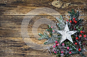 Christmas star on fir tree branches and red berries decoration