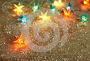 Christmas star lights frame on wooden background with copy space