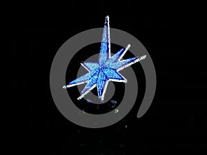 Christmas star at night shining blue light