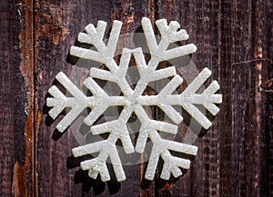 Christmas star snowflake decoration on age weathered wood wall texture