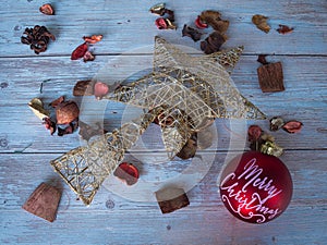 Christmas star on white table and dry leaves background