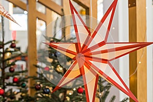 A Christmas star in the window. Warm light, Christmas, cosy atmosphere. Advent time.Paper lightning lantern in star form