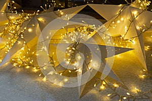 Christmas start with lights background. Nativity star, blurred lights, indoor and outdoor decorations for new year
