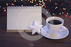 Christmas still life with coffee cup with a saucer and a notebook