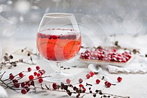 Christmas still life with cranberriy punch and blurred snow outside the window. Festive and bright