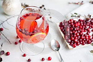 Christmas still life with cranberriy punch and blurred snow outside the window. Festive and bright