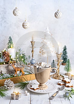 Christmas still life with cup of hot chocolate, gingerbread cookies, candles, Christmas ornaments. Winter cozy home concept