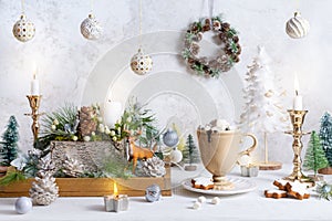 Christmas still life with cup of hot chocolate, gingerbread cookies, candles, Christmas ornaments. Winter cozy home concept