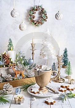 Christmas still life with cup of hot chocolate, gingerbread cookies, candles, Christmas ornaments. Winter cozy home concept