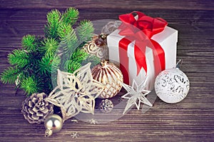 Christmas still life with fir gift and tinsel on wooden board