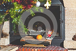 Christmas still life in fireplace. Christmas tree, tangerine, Santa Claus