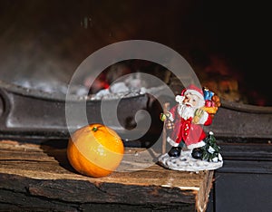 Christmas still life in fireplace. Christmas tree, tangerine, Sa