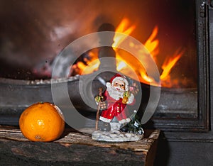Christmas still life in fireplace. Christmas tree, tangerine, Sa