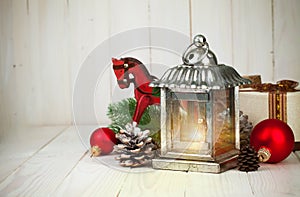 Christmas still life with lamp balls and gift on wooden board