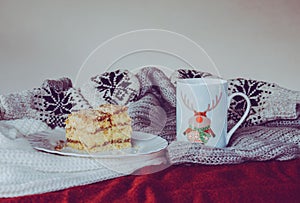 Christmas still life with sweaters, hot drink and dessert