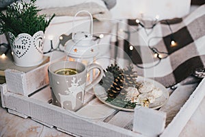 Christmas still life with tea, lights, cones and cookies