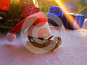 Christmas still life of a toy sled, Vintage photo, Gifts for Christmas on wooden sled, Merry Christmas tree transporter