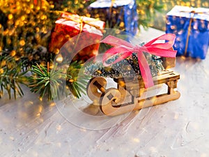 Christmas still life of a toy sled, Vintage photo, Gifts for Christmas on wooden sled, Merry Christmas tree transporter