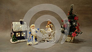 Christmas still life, toys Santa Claus and snow maiden violinist near the Christmas tree