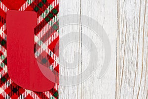 Christmas stocking on buffalo plaid border material holiday background on weathered wood