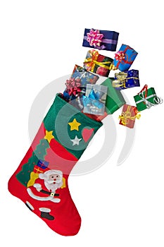 Christmas stocking and gifts isolated over white.