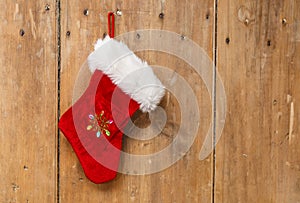 Christmas stocking hanging on an old pine wooden door