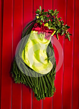Christmas stocking with pine background and holly leaves