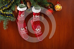 Christmas stocking pine cones and branches. decorations on wooden rustic background