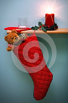 Christmas stocking with presents and milk glass.