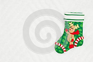 Christmas stocking with a reindeer on white chevron textured fabric background