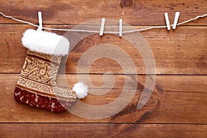 Christmas stocking sock hanging on brown wooden background, merry xmas and happy New year card, copy space, top view