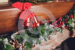 Christmas stockings hanging over a fireplace with candles on the mantlepiece.