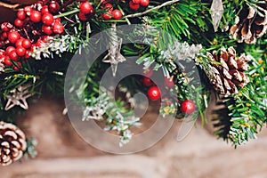 Christmas stockings hanging over a fireplace with candles on the mantlepiece.