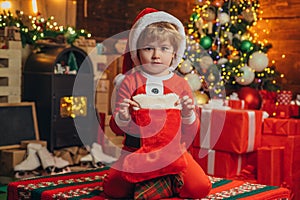 Christmas stockings, Little boy with Christmas presents in sock. Happy new year. Indoor. Merry and bright christmas