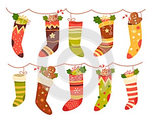 Christmas stockings with traditional sweets and decoration hanging on rope set vector illustration