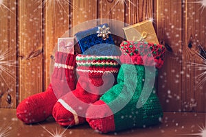 Christmas stockings on wooden background. Vintage style