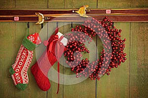 Christmas stockings and wreath hanging on wall