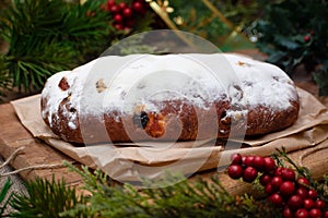 Christmas stollen its a Traditional Dresdner German Christmas cake Stollen with raising, berries and nuts. Christmas decorations