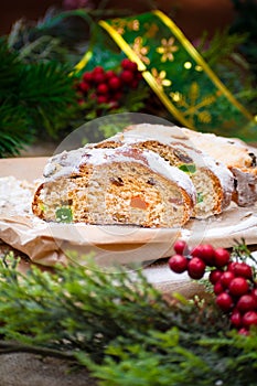 Christmas stollen its a Traditional Dresdner German Christmas cake Stollen with raising, berries and nuts. Sliced stollen on paper