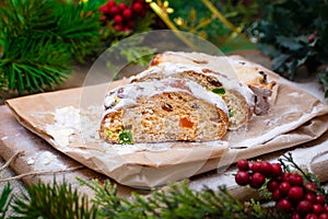 Christmas stollen its a Traditional Dresdner German Christmas cake Stollen with raising, berries and nuts. Sliced stollen on paper