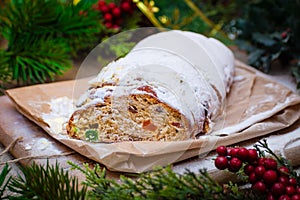 Christmas stollen its a Traditional Dresdner German Christmas cake Stollen with raising, berries and nuts. Sliced stollen on paper