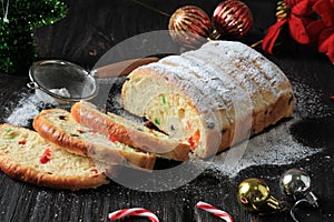 Christmas Stollen. Traditional Sweet Fruit Loaf with Icing Sugar. Xmas Holiday Table Setting, Decorated with Mini Tree Christmast