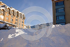 A Christmas Story in Whistler  village - Snow-covered buildings - on the roofs, Ski resort. A cold but clear sunny winter day.