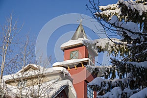 A Christmas Story in Whistler  village - Snow-covered buildings - on the roofs, Ski resort. A cold but clear sunny winter day.