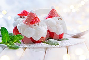 Christmas strawberry Santa. Funny dessert stuffed with whipped cream