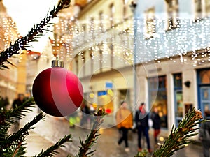 Christmas street life in the city ,green tree decorated with red balls and illumination,people walking  ,holiday travel to Medieva photo