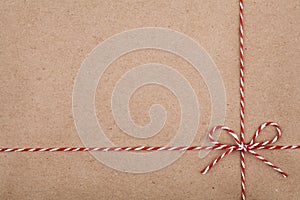 Christmas string or twine tied in a bow on kraft paper backdrop