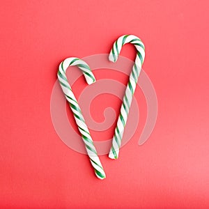 Christmas striped green and white heart shaped hard candies on red backgraund.