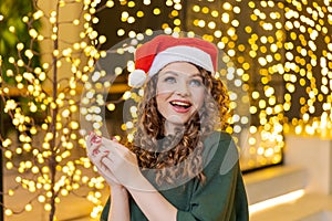 Christmas surprised winter woman. Beauty model girl in santa hats over festive