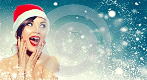 Christmas. Surprised woman in Santa`s hat photo